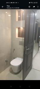 a bathroom with a toilet in a glass door at City Beautiful Home One room Suite in Panchkula