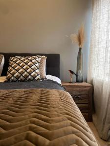 a bedroom with a bed and a vase on a table at Stylish apartment @ city centre in Rotterdam