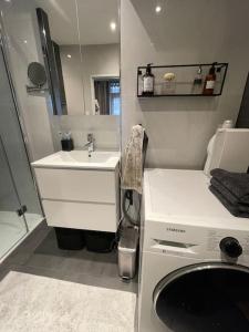 a small bathroom with a sink and a mirror at Stylish apartment @ city centre in Rotterdam