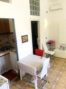 a room with a table and a kitchen with a table and chairs at P4T Holidays Home - city center in Brindisi