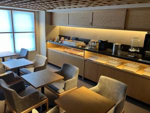 a restaurant with tables and chairs and a counter at THE GENERAL KYOTO Shijou Shinmachi in Kyoto