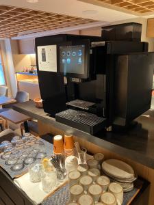 a kitchen with a counter with dishes and a microwave at THE GENERAL KYOTO Shijou Shinmachi in Kyoto