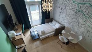 mały pokój z łóżkiem, stołem i krzesłami w obiekcie DROINVEST Apartament Zarembowicza 33 WROCŁAW LOTNISKO AIRPORT we Wrocławiu