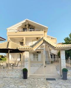 a large house with a gate in front of it at Villa Elva in Ammoudia