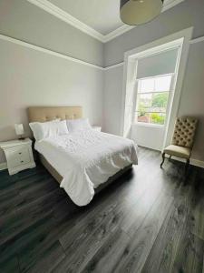 a bedroom with a bed and a window and a chair at Beach lodge with Hot Tub in Ayr