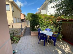 a table and chairs sitting on a patio at Regina House Cattolica in Cattolica