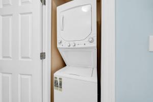 a white washer and dryer in a room at Boardwalk 1209 in Panama City Beach