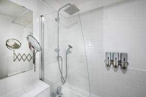 a bathroom with a shower with a glass door at Train Station Serenity in Staines upon Thames