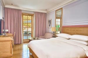 um quarto com uma grande cama branca e uma janela em Palmyard Hotel em Manama
