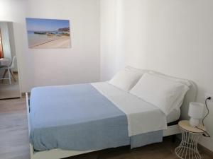 a bedroom with a bed and a picture of a beach at Casa dei Mulini in Favignana