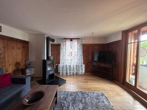 a living room with a couch and a tv at Haus Sonnenblick in Düns