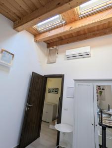 a room with a door and a ceiling with skylights at A Casa di Sonia in Syracuse