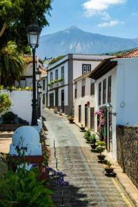 a cobble stone street with buildings and a street light at The Palm Villa rural beachside in Icod de los Vinos