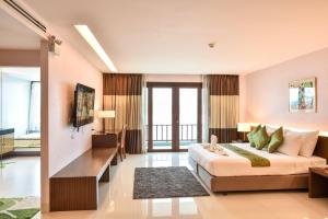 a hotel room with a bed and a couch at Siam Triangle Hotel Chiang Sean in Chiang Saen