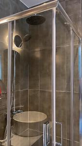 a shower stall with a tub in a bathroom at no.21house studio apartment in Rio