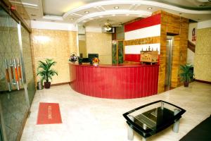 a lobby with a red counter in a building at Hotel Sunpark Inn in Chennai
