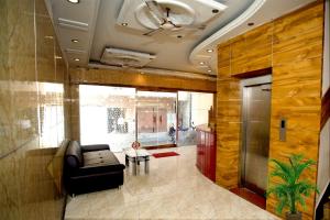 a living room with a couch and a table at Hotel Sunpark Inn in Chennai