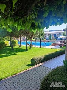 einen Backsteinsteg neben einem Pool mit einem Resort in der Unterkunft Apartments Atia Resort in Tschernomorez