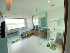 a bathroom with a toilet and a sink and a mirror at Siam Triangle Hotel Chiang Sean in Chiang Saen +62 photos