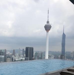 a pool on the roof of a building with a view of a city at Pool View Platinum KLCC in Kuala Lumpur