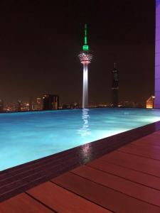 a view of the space needle at night at Pool View Platinum KLCC in Kuala Lumpur