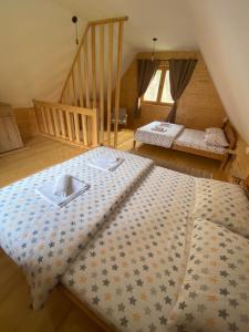 a large bed in a room with a staircase at Apartman Lenka in Mokra Gora