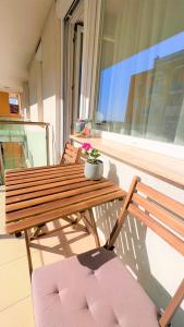 a wooden table and two chairs on a balcony at Happy Living Apartment w Balcony in Budapest
