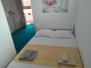 a small bed with two towels on top of it at Casa Octavia in Schitul