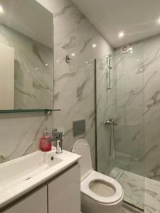 a bathroom with a shower and a toilet and a sink at Eleana's apartments in Gouvia +42 photos