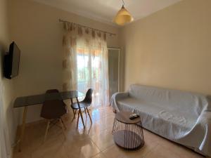 a living room with a couch and a table at Eleana's apartments in Gouvia