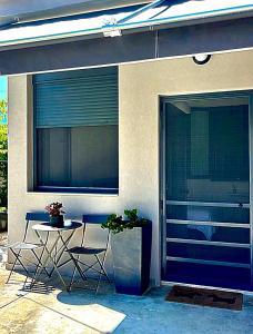 a patio with a table and chairs next to a building at no.21house studio apartment in Rio