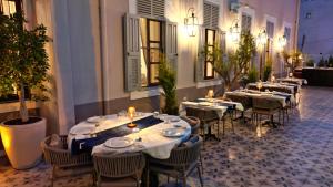 a row of tables and chairs in a restaurant at Rasim Palas - Adults Only in Cesme