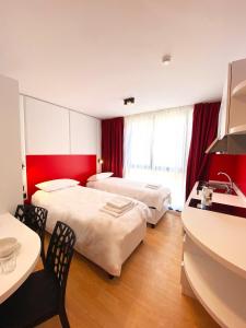 a hotel room with two beds and a table at Citizen Suites in Sliema