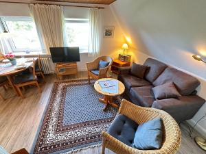 a living room with a couch and a table at Haus-Inken-Maria-West in Westerland (Sylt)