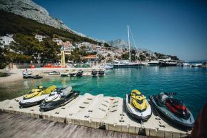 a group of boats sitting on a dock in the water at Partners Perfect Place in Brela
