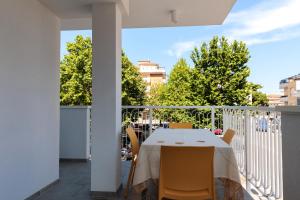 a balcony with a table and chairs on it at Centenarium Eco residenza in Porto SantʼElpidio