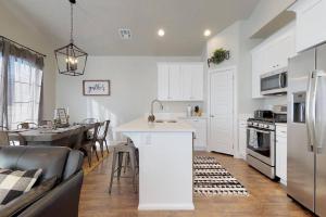 a kitchen with white cabinets and a kitchen island in a room at Good To Be Home where your family can relax in Washington