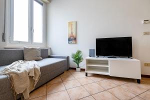 a living room with a couch and a flat screen tv at Shakira Apartments in Parma