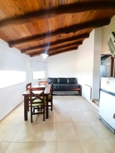 a living room with a table and a couch at Aromas del Alba in San Clemente del Tuyú