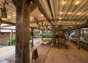 a patio with tables and chairs in a building at High Paradise Farm in Thirsk