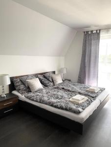 a bedroom with a large bed with two pillows on it at Lux apartments in Orosháza +18 photos