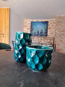 two blue vases sitting on top of a table at jardin kapetanova kuća in Veli Iž
