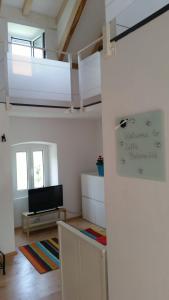 a living room with a loft bed and a staircase at Holiday Home Bobovisca in Ložišće