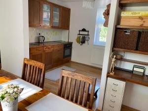 a kitchen with a table and two chairs and a table and a kitchen with at Modrá chaloupka in Opařany