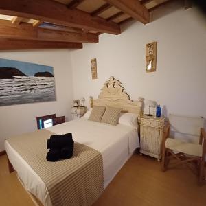 a bedroom with a bed with a black bag on it at Casa en Ferreries in Ferreries