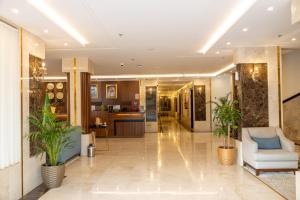 a lobby of a hotel with two plants at Ramz Al Diyafa 1 in Taif