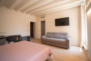 a living room with a couch and a table at Maison Calcirelli rooms in Verona