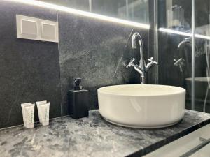 a bathroom with a sink and a glass shower at Baltic Gdańsk OLD TOWN in Gdańsk +110 photos