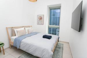 a bedroom with a bed with a flat screen tv at Luxury 2BR Central TLV Apartment in Tel Aviv