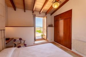 a bedroom with a large bed and a window at Dels BOUS 163 SINEU in Sineu